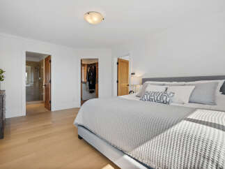 Experience luxury and convenience in this master suite, featuring a spacious walk-in closet and an en-suite bathroom with a modern shower.