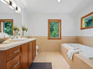 Indulge in relaxation in this luxurious bathroom featuring a spacious soaking tub perfect for unwinding.