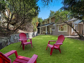 Enjoy the outdoors in this spacious backyard featuring a lush green lawn perfect for recreation and relaxation.