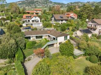 Nestled on a lush hillside, this property offers stunning panoramic views and a serene living environment.