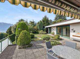 Enjoy stunning lake and mountain views from this exquisite property, featuring a spacious patio perfect for outdoor entertaining.