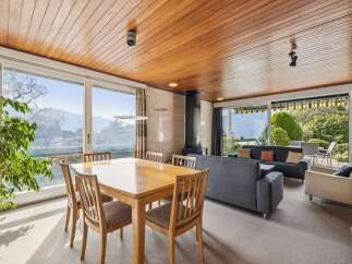 Experience breathtaking mountain and lake views from this stunning living and dining area.