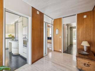 Step into a home with a unique blend of mid-century modern design and natural wood accents.