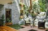 Experience tranquility in this stunning indoor oasis, featuring a serene koi pond and a lush, tropical garden.