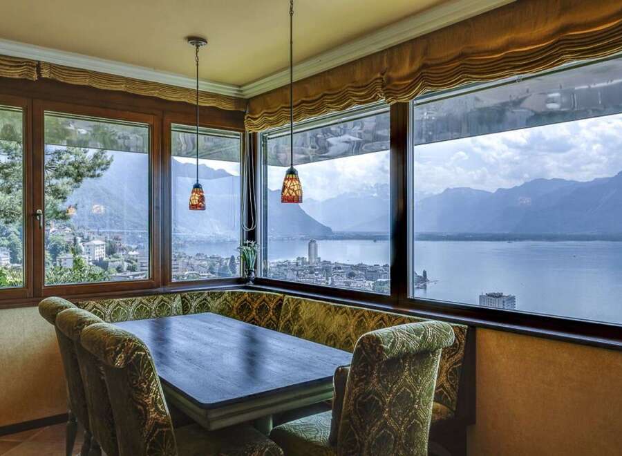 Experience breathtaking panoramic views of the lake and mountains from this exquisite dining area.