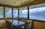 Experience breathtaking panoramic views of the lake and mountains from this exquisite dining area.