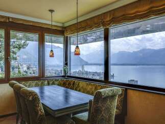 Experience breathtaking panoramic views of the lake and mountains from this exquisite dining area.