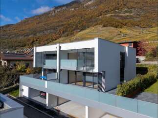 Discover modern living in this stunning multi-unit property, featuring sleek white architecture and expansive glass balconies.