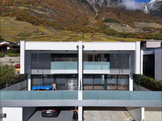 Experience modern living with this stunning property featuring expansive balconies and large windows that offer breathtaking views of the surrounding vineyards and mountains.