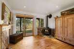 Cozy living room featuring a rustic wood-burning stove set against a stone hearth, perfect for chilly evenings.