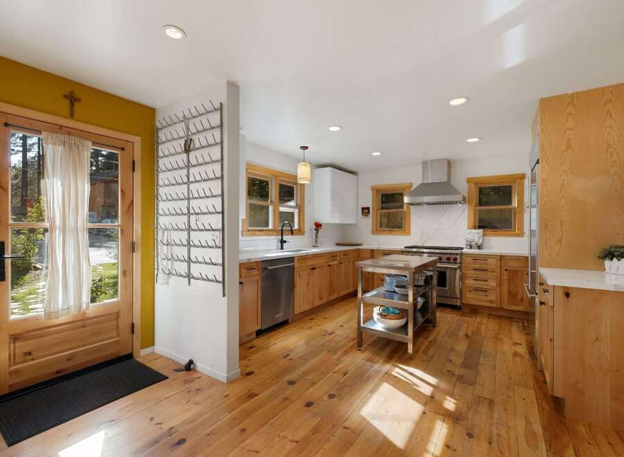 Step into this charming kitchen featuring warm, natural wood cabinetry and a spacious island perfect for meal prep.