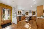 Step into this charming kitchen featuring warm, natural wood cabinetry and a spacious island perfect for meal prep.