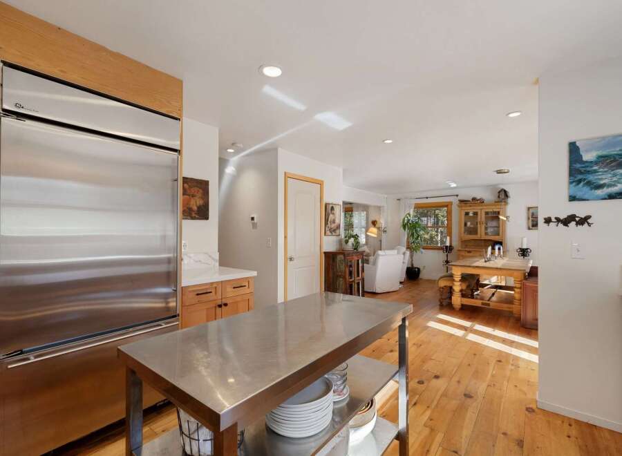 Experience the perfect blend of modern and rustic charm in this spacious kitchen and dining area.