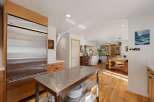 Experience the perfect blend of modern and rustic charm in this spacious kitchen and dining area.