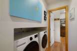 This laundry room features a stacked LG ThinQ washer and dryer set, perfect for efficient cleaning.