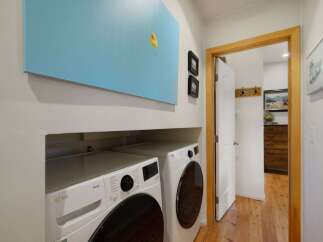 This laundry room features a stacked LG ThinQ washer and dryer set, perfect for efficient cleaning.