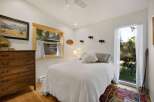 Experience rustic charm in this cozy bedroom, featuring a comfortable bed adorned with plush pillows and a textured quilt.