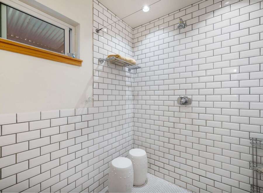 Experience a spa-like retreat in this stunning bathroom featuring a spacious walk-in shower with classic white subway tile and sleek chrome fixtures.