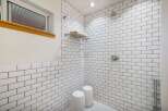 Experience a spa-like retreat in this stunning bathroom featuring a spacious walk-in shower with classic white subway tile and sleek chrome fixtures.