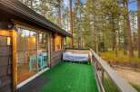 Enjoy the serene mountain setting from this charming cabin's private deck, complete with artificial turf for easy maintenance.