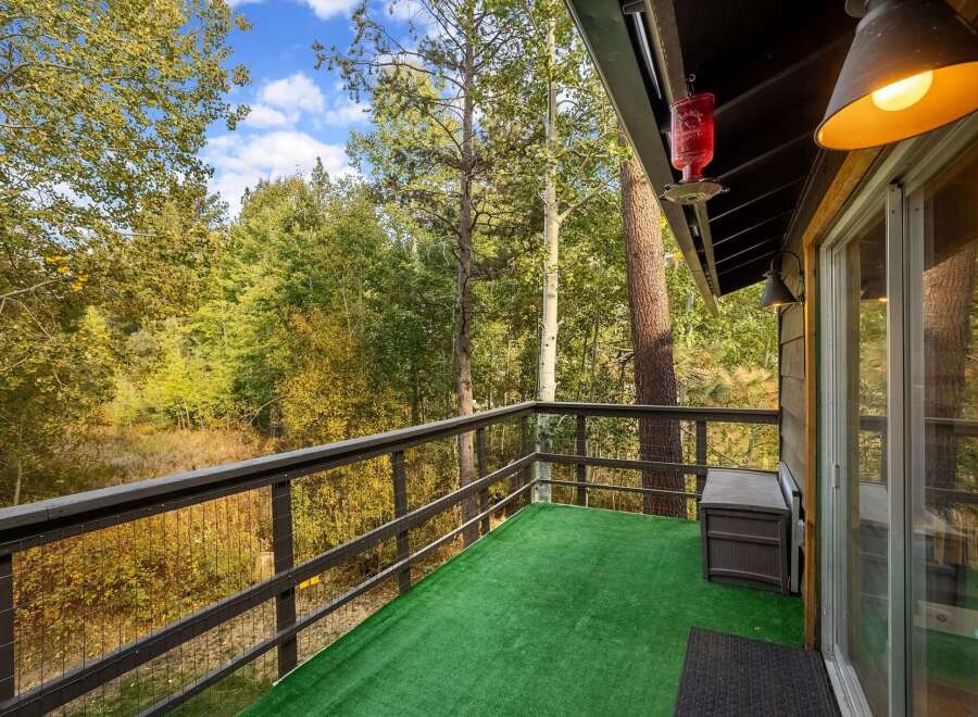 Enjoy breathtaking forest views from this charming balcony, perfect for morning coffee or evening relaxation.