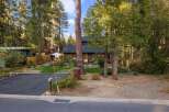 Nestled amongst tall pine trees, this charming cabin offers a serene retreat.