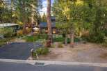 Charming cabin nestled among tall pine trees, offering a serene retreat.
