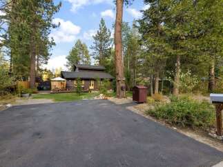 Nestled among tall pine trees, this charming cabin offers a serene retreat.