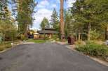 Charming cabin nestled among tall pine trees, offering a serene mountain retreat.