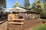 Enjoy outdoor living on this charming property featuring a spacious wooden deck perfect for entertaining.