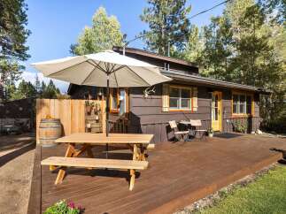 Enjoy outdoor living on this charming property featuring a spacious wooden deck perfect for entertaining.