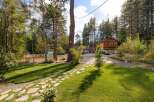 Discover this charming property featuring a beautifully maintained lawn and a picturesque stone pathway leading to the entrance.