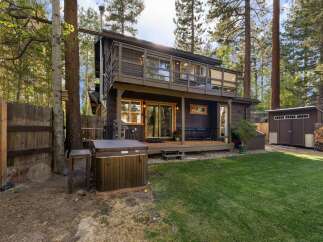 Escape to this charming cabin nestled among tall pine trees, offering a private backyard oasis.