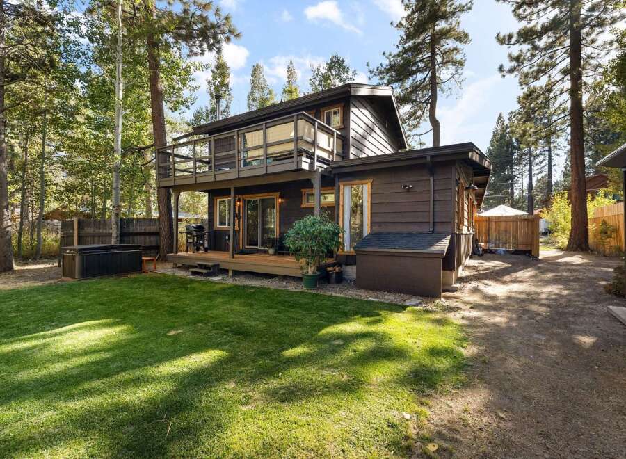 Enjoy outdoor living with this charming property featuring a spacious deck and a relaxing hot tub, perfect for unwinding.