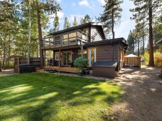 Enjoy outdoor living with this charming property featuring a spacious deck and a relaxing hot tub, perfect for unwinding.