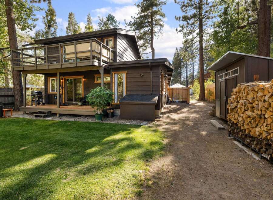 Enjoy outdoor living with this charming property featuring a spacious deck perfect for entertaining and a lush green lawn ideal for relaxation.