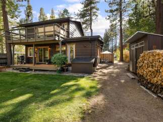 Enjoy outdoor living with this charming property featuring a spacious deck perfect for entertaining and a lush green lawn ideal for relaxation.