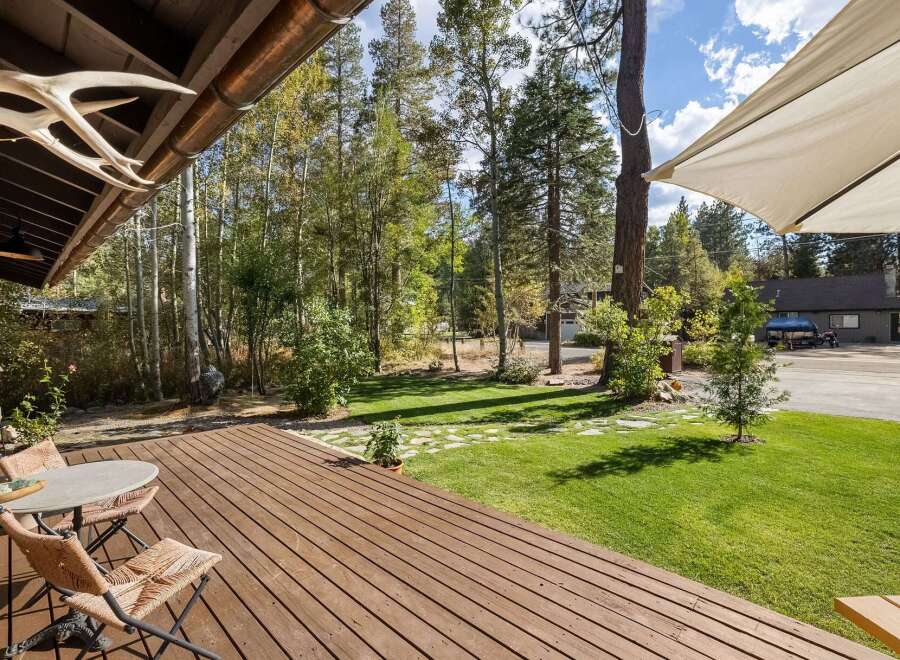 Enjoy outdoor living on this spacious wooden deck, perfect for morning coffee or evening relaxation.