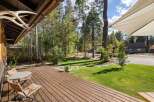 Enjoy outdoor living on this spacious wooden deck, perfect for morning coffee or evening relaxation.