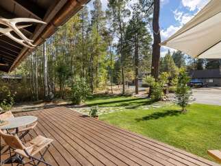 Enjoy outdoor living on this spacious wooden deck, perfect for morning coffee or evening relaxation.