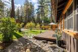 Enjoy outdoor living in this charming home featuring a spacious wooden deck perfect for entertaining.