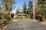 Nestled amidst tall pine trees, this charming cabin offers a serene mountain retreat.