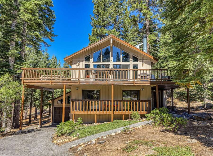 Nestled amidst tall pine trees, this charming mountain home offers a serene retreat.