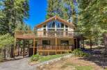 Nestled amidst tall pine trees, this charming mountain home offers a serene retreat.