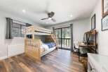 This charming bedroom features a sturdy wooden bunk bed, perfect for accommodating guests or family.