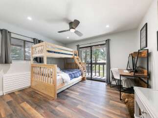 This charming bedroom features a sturdy wooden bunk bed, perfect for accommodating guests or family.