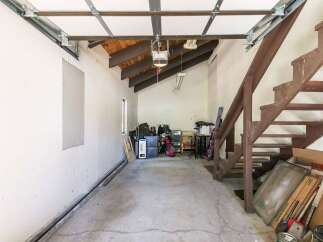 Discover ample storage and potential in this versatile garage space.