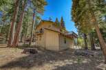 Nestled amongst tall pine trees, this charming home offers a serene mountain retreat.