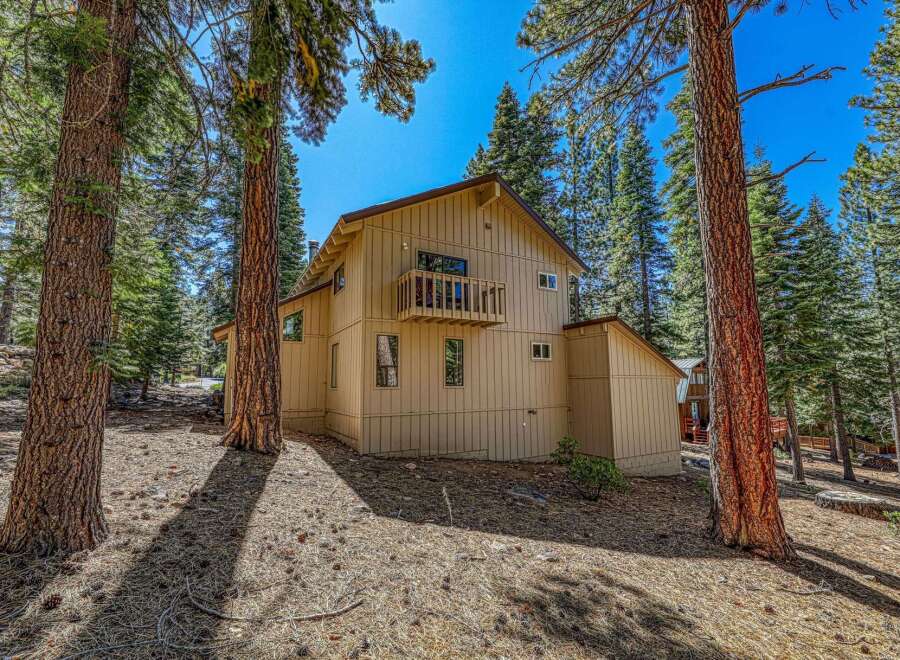 Nestled among tall pine trees, this charming home offers a serene mountain retreat.