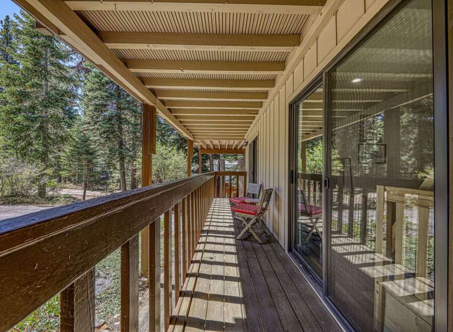 Enjoy the serene mountain setting from this charming covered porch, perfect for morning coffee or evening relaxation.